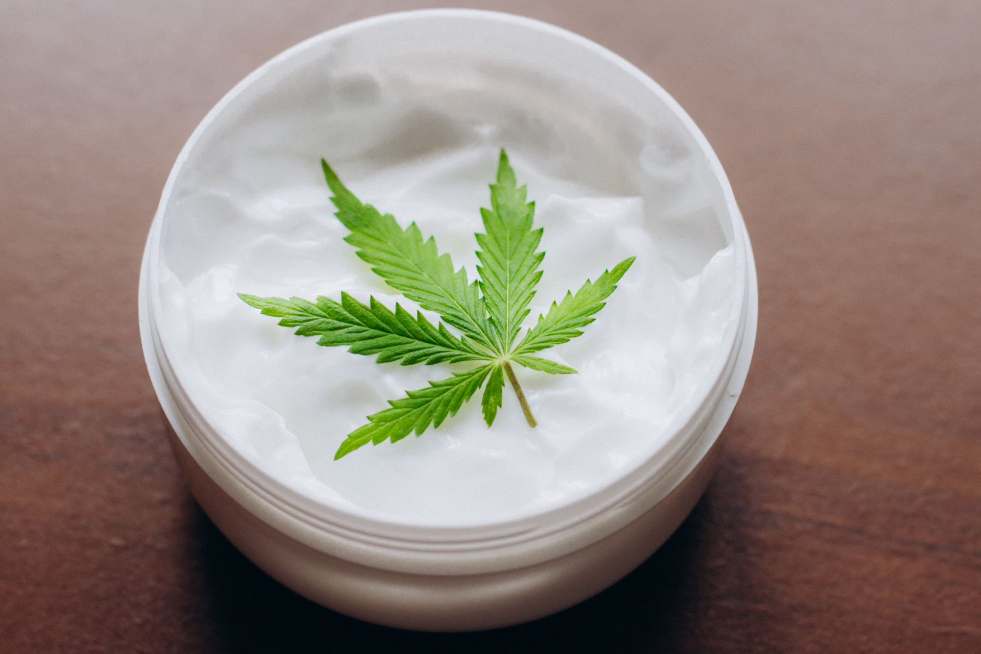 cbd cream with marijuana leaf