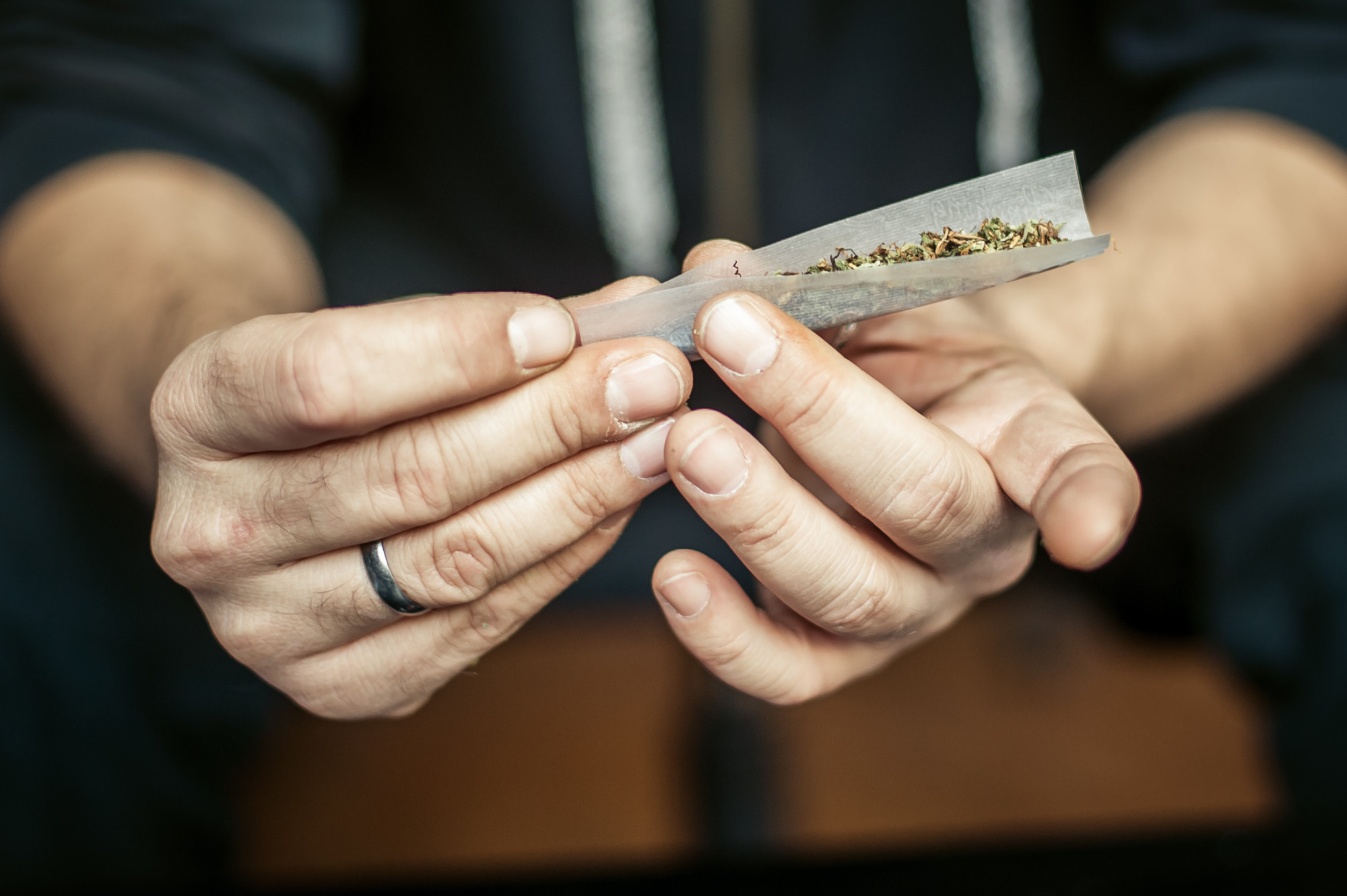 person rolling a joint