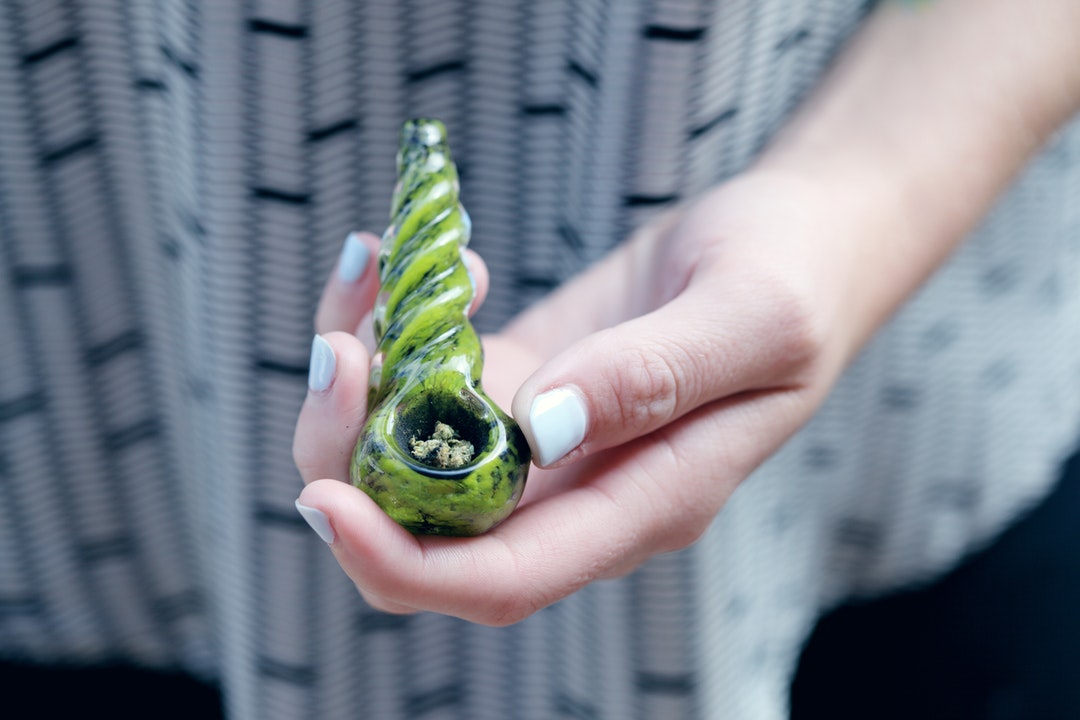 weed in a bowl held by girl